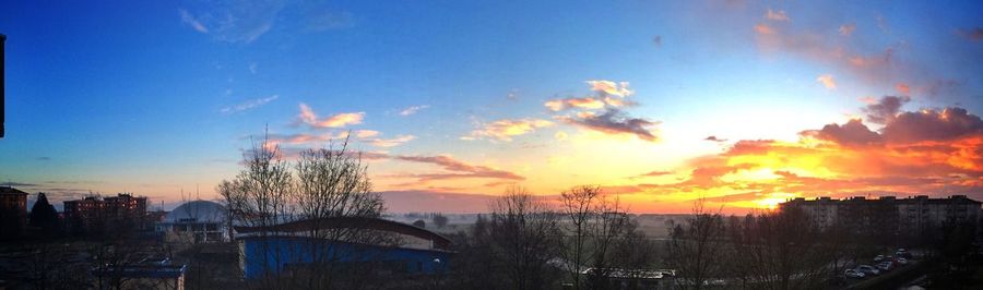 Buildings against sky at sunset