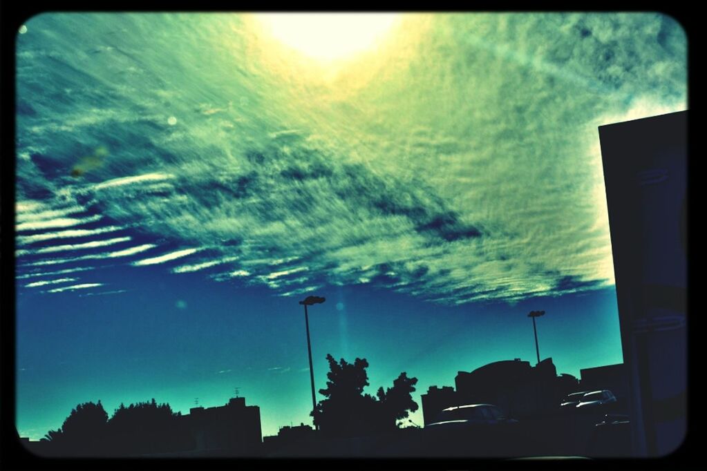 transfer print, sky, auto post production filter, street light, cloud - sky, silhouette, building exterior, transportation, built structure, car, low angle view, nature, cloud, architecture, illuminated, dusk, sunset, no people, outdoors, mode of transport