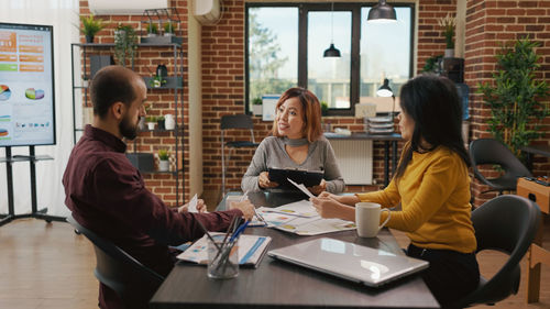 Business colleagues having discussion at office