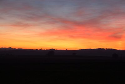 Silhouette landscape against sky during sunset