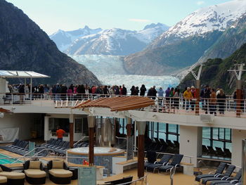 People at restaurant against mountains