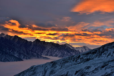 Scenic view of snowcapped mountains against sky during sunset