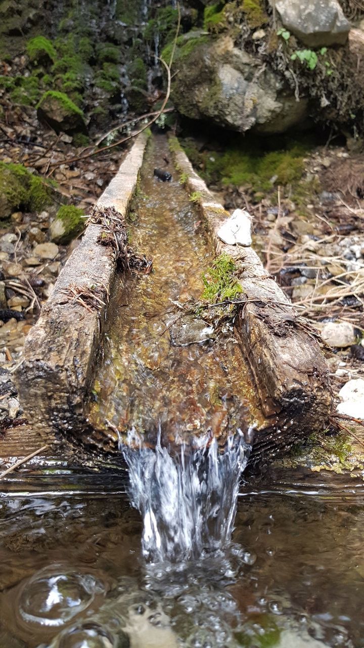 VIEW OF STREAM FLOWING THROUGH ROCKS