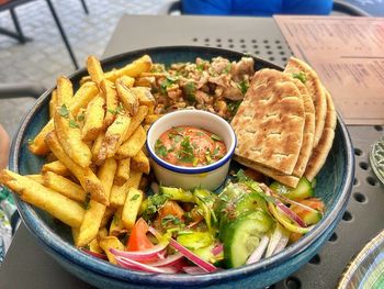 Large deep plate with shawarma, homemade thick fries, sauce, pita bread, pieces of grilled chicken
