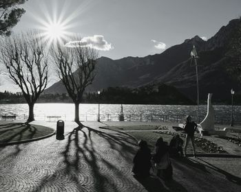 Scenic view of lake by mountains against sky