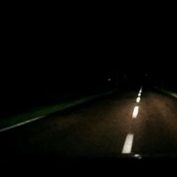 View of illuminated road at night