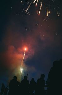 Low angle view of firework display at night