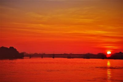 Scenic view of sea against romantic sky at sunset