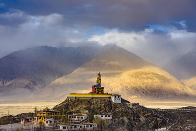 Traditional building against cloudy sky