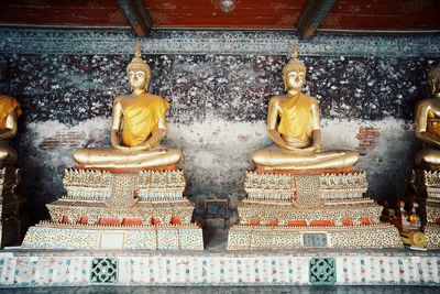 Statue of buddha against building