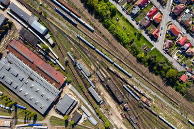 Aerial drone view of old locomotive train depo, parking iron horses on railway routes. diesel engine