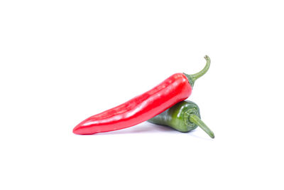 Close-up of red chili pepper against white background