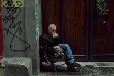 Side view of man sitting on seat