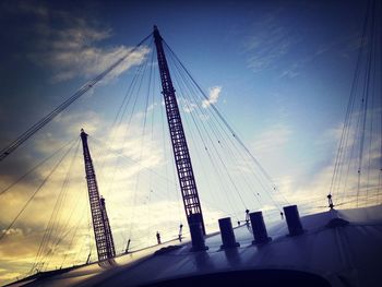 Low angle view of electricity pylon against sky