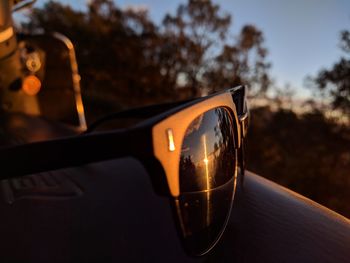 Close-up of illuminated lamp against sky at sunset