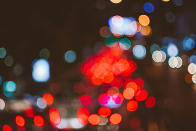 Defocused image of illuminated city at night