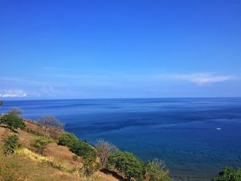 High angle view of sea against blue sky