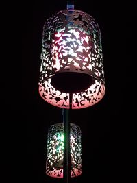 Close-up of illuminated lamp against black background