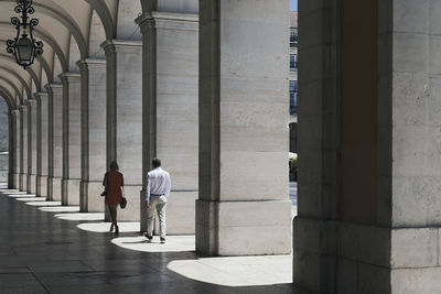 Rear view of people walking in building