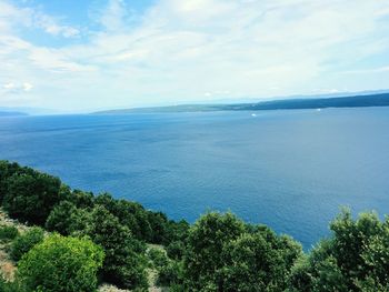 Scenic view of calm sea against cloudy sky