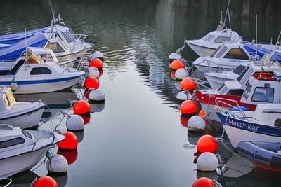 Boats moored in lake against sky