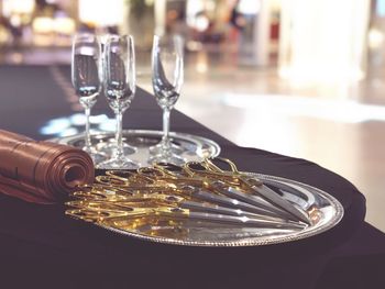 Scissors with napkins and champagne flutes on table