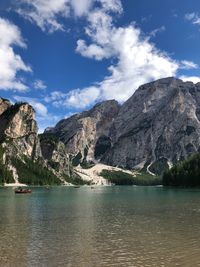 Scenic view of lake and mountains against sky