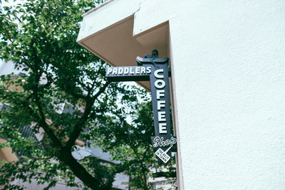 Low angle view of information sign against building