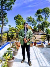Full length of man standing against plants