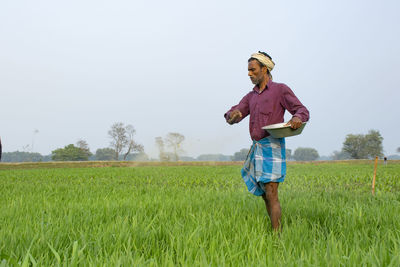 Full length of man standing on field against sky