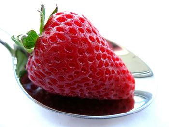 Close-up of strawberry over white background