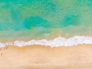 High angle view of waves rushing towards shore