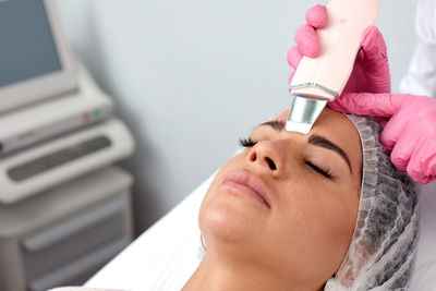 Midsection of doctor examining patient in clinic