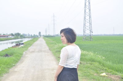 Side view of young woman standing on land