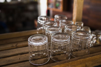 Close-up of empty upside down glasses on wooden table