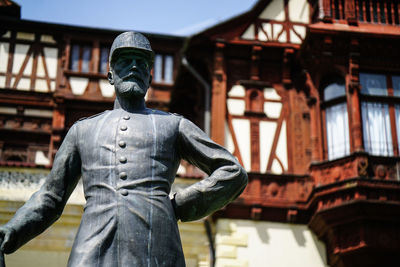 Low angle view of statue against historic building