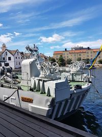 Boats moored in sea against buildings in city