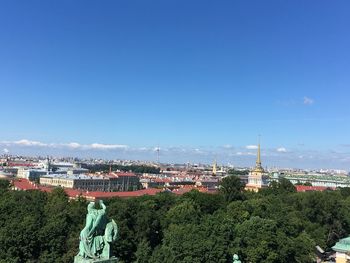 Buildings in city against blue sky