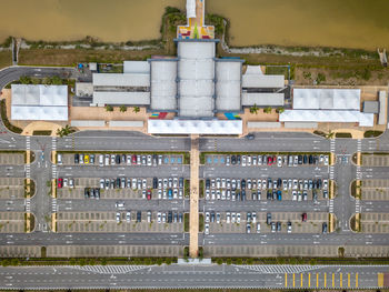 Aerial view of cars parked on road against sea