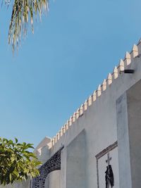 Low angle view of palm trees against sky