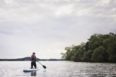 Woman paddle boarding on river