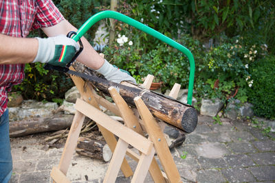 Close-up of hand cutting wood