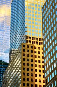 Low angle view of modern glass building in city