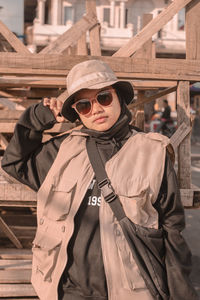 Portrait of woman wearing sunglasses standing outdoors