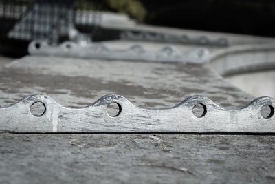 Close-up of metallic locks on retaining wall
