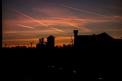 Silhouette buildings against sky during sunset