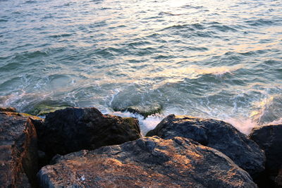 High angle view of rocks by sea