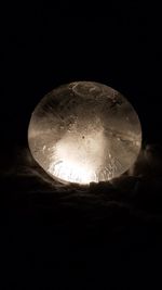 Low angle view of illuminated moon against sky at night