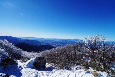 Scenic view of mountains against clear blue sky