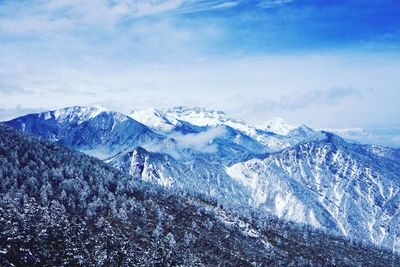 Scenic view of snowcapped mountain against cloudy sky